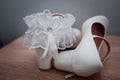 White shoes and bridal garter. Bride morning. Bride& x27;s accessories Royalty Free Stock Photo