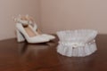 White shoes and bridal garter. Bride morning. Bride's accessories Royalty Free Stock Photo