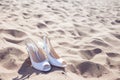 White shoes the bride on a sandy beach, closeup
