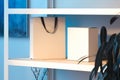 White shopping bag with black handles and box on wooden shelf. 3d rendering. Royalty Free Stock Photo