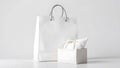 Clean white shopping bag and gift box with ribbon on white background Royalty Free Stock Photo