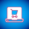 White Shopping cart on screen laptop icon isolated on blue background. Concept e-commerce, e-business, online business Royalty Free Stock Photo