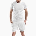 White shorts mockup with underpants compression line, men`s t-shirt on a man, isolated on background