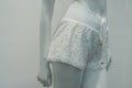 White shorty on mannequin in fashion store showroom for women