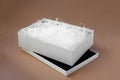 white shredded paper in a white open box on the lid on a paper beige background for protection during delivery Royalty Free Stock Photo