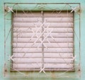 White shutters closed on window behind white metal grill on fade Royalty Free Stock Photo