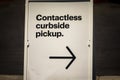 Sign advertising Contactless Curbside Pickup at retail store parking lot