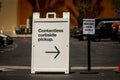 Sign advertising Contactless Curbside Pickup at retail store parking lot Royalty Free Stock Photo