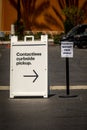 Sign advertising Contactless Curbside Pickup at retail store parking lot Royalty Free Stock Photo