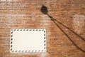 White sign on brick wall with lamp shadow Royalty Free Stock Photo
