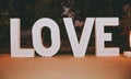White sign love light bulbs on wooden background. Royalty Free Stock Photo