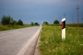 White sign on the road on the grass