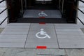 White sign of wheelchair on gray floor front doorway. Royalty Free Stock Photo