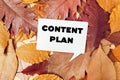 White sign with the word content plan written on it is placed on top of a pile Royalty Free Stock Photo