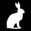 white silhouette of a rabbit or hare sitting on a black background.