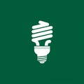White silhouette of a compact fluorescent light bulb on a solid green background. The Royalty Free Stock Photo