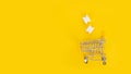 White silicone finger separator and shopping cart on yellow background.