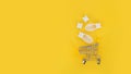 White silicone finger separator and shopping cart on yellow background.