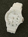 White silicone wrist watch close up photo. Date marker added trendy sports wear. Royalty Free Stock Photo