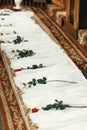 White silk textile at aisle with red roses, decor in church at w Royalty Free Stock Photo