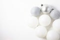 White and silver Christmas tree balls on a light background, the concept of celebration and joy. Top view Royalty Free Stock Photo