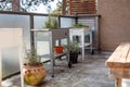 A white and silver galvanized elevated garden planter sits on an apartment patio