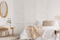 White simple bedroom design with mirror and bed with white sheets Royalty Free Stock Photo