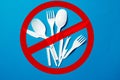 White single-use plastic knives, spoons, forks on a blue background. Say no to single use plastic. Environmental, pollution Royalty Free Stock Photo