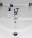 White sink and toothbrushes Royalty Free Stock Photo