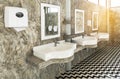 White sinks on raw concrete wall Royalty Free Stock Photo