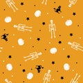 White skeletons and pumpkins with black cats and dots on orange background. Seamless repeat halloween pattern. Happy halloween
