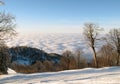 White ski slope above puffy clouds Royalty Free Stock Photo