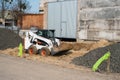 White skid steer loader at a construction site working with a soil. Industrial machinery. Industry. Royalty Free Stock Photo