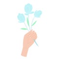 White skin hand holding blue flowers. Isolated hand holding bouquet