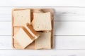 White sliced bread on wood plate, top view and copy space