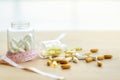 White slimming pills in glass bottles and measure And yellow pill capsules in falling glass bottles And drugs distributed