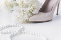 White slipper boat with hairpin, white hydrangea flowers, pearl necklace, beads Royalty Free Stock Photo
