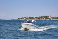 White small boat with motor and roof in the Gulf bay of Venice in blue sea water Royalty Free Stock Photo