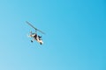 White small double gyroplane autogyro without a cabin against the blue sky. Air tours for tourists