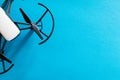 white small drone on blue surface. electronic high tech toys. Flat lay quadcopter on colored background. Copyspace for text Royalty Free Stock Photo