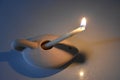 White small lit candle in a ceramic stand in the evening, for the holiday of lights of Hanukkah