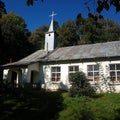 White small Old fashioned country church in rural area under blue sky Royalty Free Stock Photo