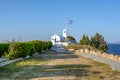 A  white small orthodox chapel dedicated to St.Nikolaos. Rafina,Greece. Royalty Free Stock Photo