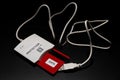 White smart card reader with white wire and with red card in the reader are on the black background/table. Note `Protection` is on Royalty Free Stock Photo