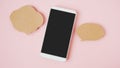 White smart phone with clipping path on touchscreen, couple of speech bubbles paper on sweet pink pastel background Royalty Free Stock Photo