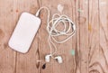 White smart phone with earphones Royalty Free Stock Photo
