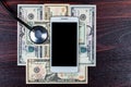 White smartphone along with American dollar bills and a stethoscope