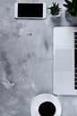 White smartphone with black blank screen on office desk with laptop and cup of coffee. Mock up of phone Royalty Free Stock Photo