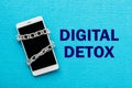 White smartphone with metal chain on blue background. Digital de