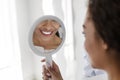 White smile in mirror, african girl visiting dentist Royalty Free Stock Photo